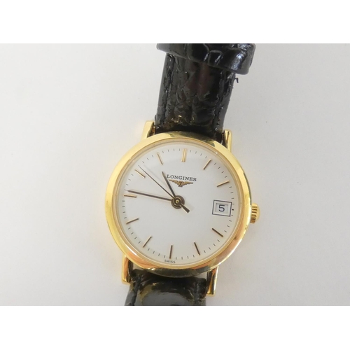 82 - Lady's 18ct Longines gold quartz watch on strap.