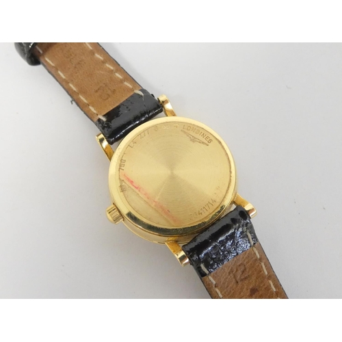 82 - Lady's 18ct Longines gold quartz watch on strap.