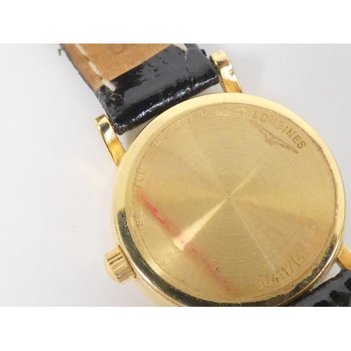 82 - Lady's 18ct Longines gold quartz watch on strap.