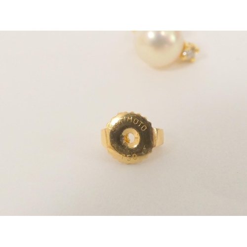 86 - Pair of Mikimoto cultured pearl and diamond ear studs in 18ct gold.