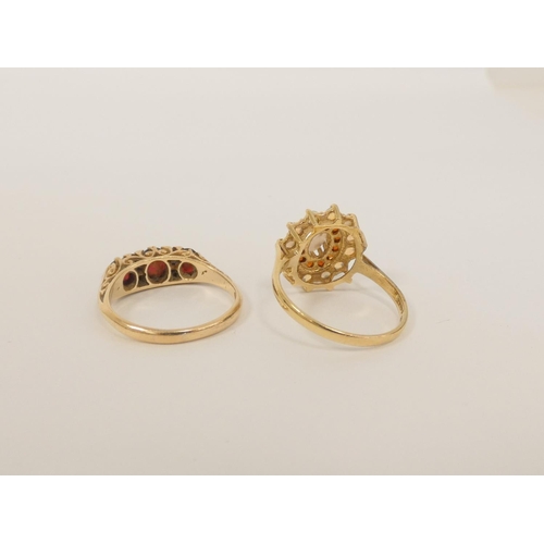 94 - Garnet half hoop ring in 9ct gold and another with opals. 6.4g gross