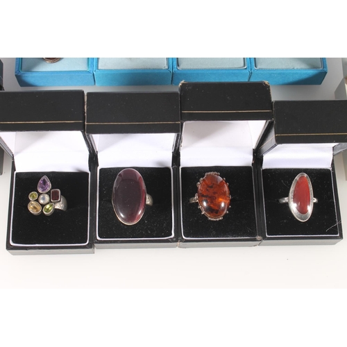 639 - Silver and other dress rings, some set with amber cabochons.