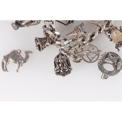 655 - Silver curb link charm bracelet and various charms, 92g gross.