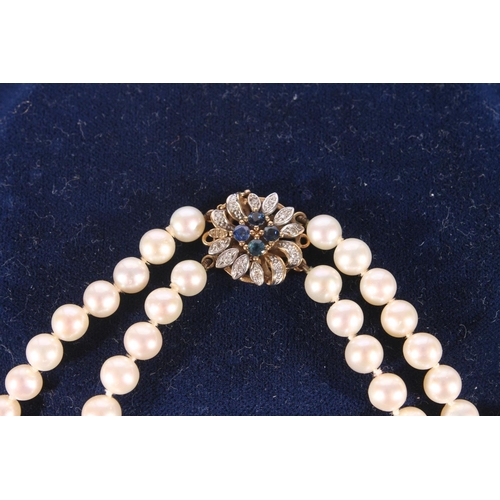 683 - Double strand pearl necklace with 9ct gold closure set with diamonds and sapphires in a flowerhead s... 