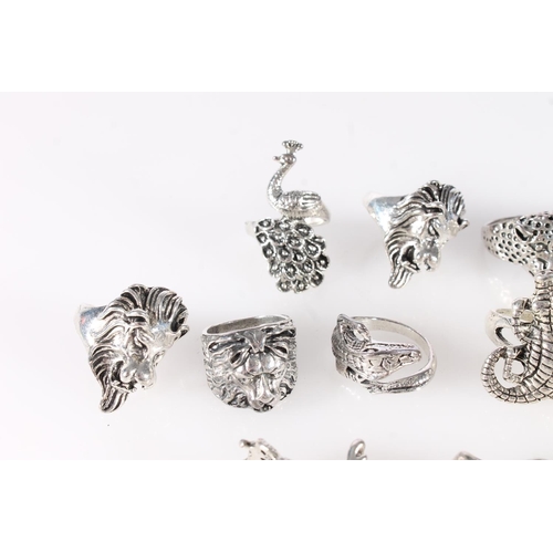 695 - Thirteen white metal animal themed dress rings to include lion, peacock, crocodile, dragon etc.