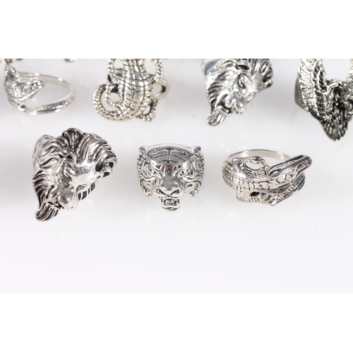 695 - Thirteen white metal animal themed dress rings to include lion, peacock, crocodile, dragon etc.