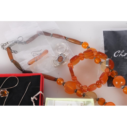 711 - Amber and faux amber jewellery to include three silver rings, silver necklaces and bracelets, pendan... 