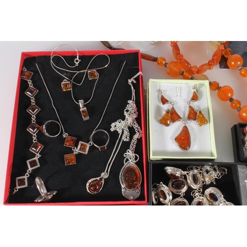 711 - Amber and faux amber jewellery to include three silver rings, silver necklaces and bracelets, pendan... 