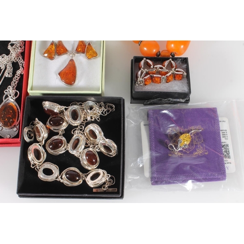 711 - Amber and faux amber jewellery to include three silver rings, silver necklaces and bracelets, pendan... 