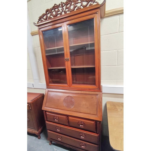 443 - 20th century Chinese rosewood bureau bookcase with carved dragon pediment, the fall front carved wit... 