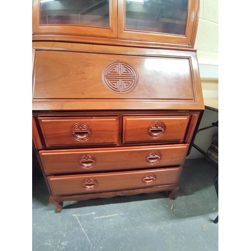 443 - 20th century Chinese rosewood bureau bookcase with carved dragon pediment, the fall front carved wit... 