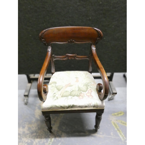 449 - Regency carved mahogany carver chair with stuff over seat raised on turned  supports  Height 90cm.