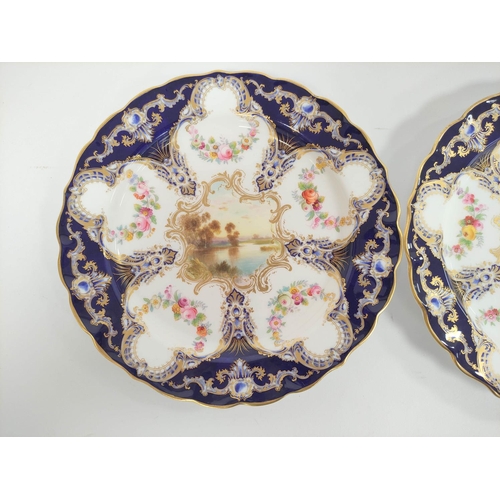 204 - Pair of Royal Worcester cabinet plates decorated with river scenes within blue and gilt borders. Dia... 