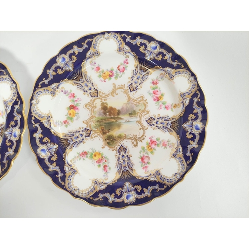 204 - Pair of Royal Worcester cabinet plates decorated with river scenes within blue and gilt borders. Dia... 