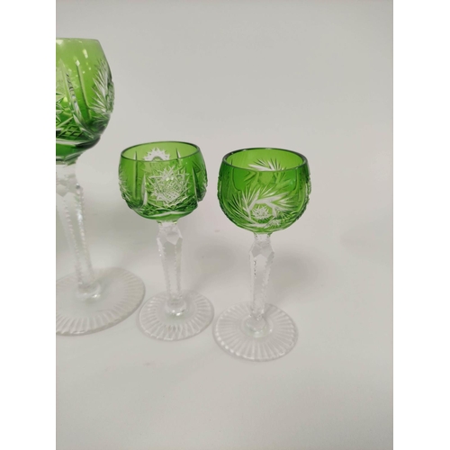 300 - Six green flashed faceted wine glasses along with six liqueur glasses of similar style. (12)