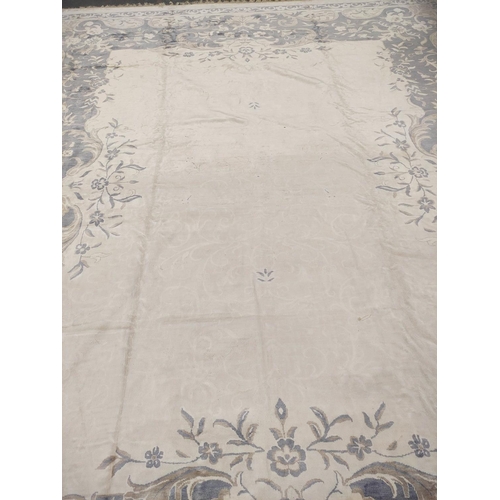 396 - Chinese style muted silk and wool carpet with central white floral panel encircled by a blue and bro... 