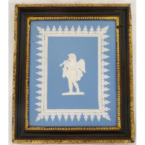 319 - Two pâte-sur-pâte tiles, c. 1885, decorated with Cupid with trap and Cupid playing a lute, on salmon... 