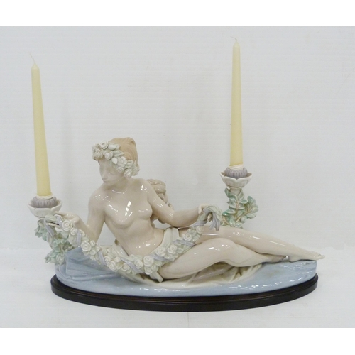 322 - Lladro candelabra modelled as a classical reclining nude female with crouching child behind, holding... 