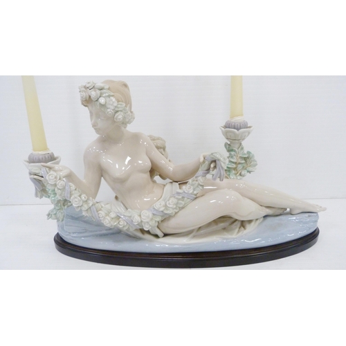 322 - Lladro candelabra modelled as a classical reclining nude female with crouching child behind, holding... 