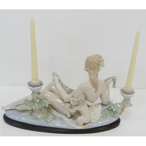 322 - Lladro candelabra modelled as a classical reclining nude female with crouching child behind, holding... 