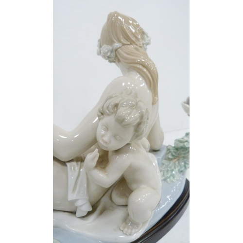 322 - Lladro candelabra modelled as a classical reclining nude female with crouching child behind, holding... 