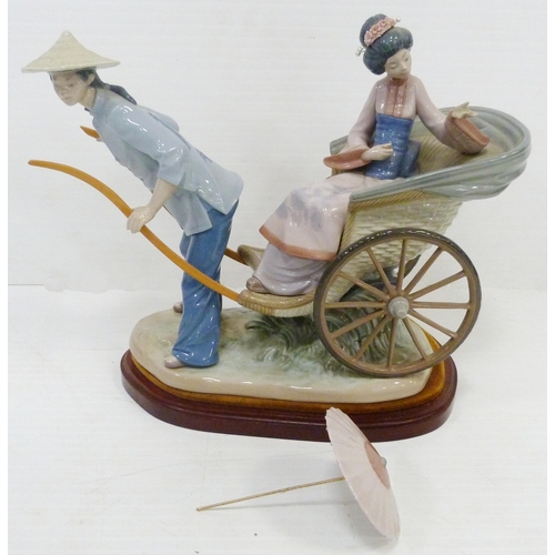 323 - Lladro figure group modelled as a Japanese Geisha with parasol in a rickshaw driven by a male, appro... 