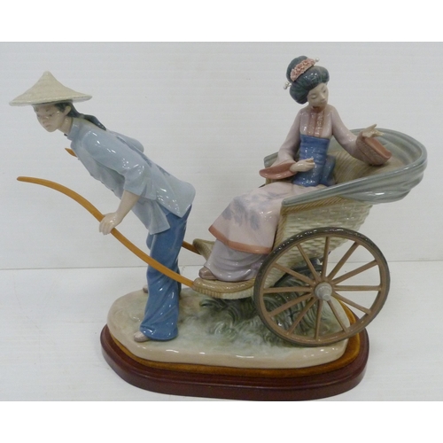 323 - Lladro figure group modelled as a Japanese Geisha with parasol in a rickshaw driven by a male, appro... 