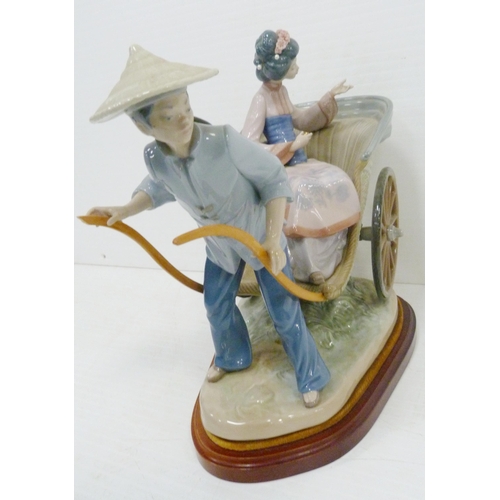 323 - Lladro figure group modelled as a Japanese Geisha with parasol in a rickshaw driven by a male, appro... 