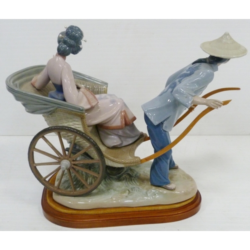 323 - Lladro figure group modelled as a Japanese Geisha with parasol in a rickshaw driven by a male, appro... 