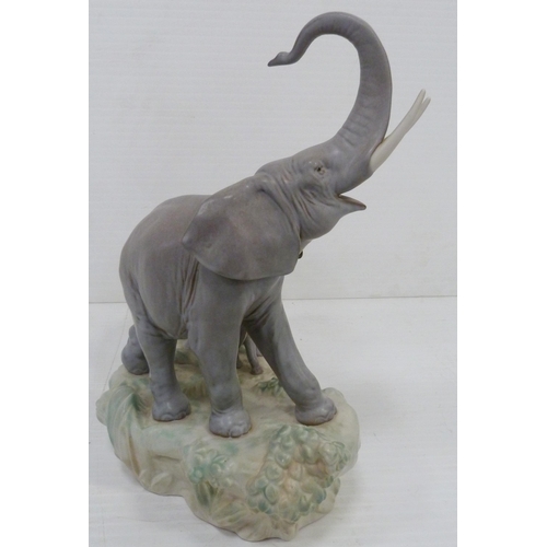 324 - Lladro matt glazed elephant group modelled as a male, female and baby elephant on naturalistic setti... 