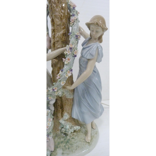 326 - Lladro lamp base in the form of two maidens decorating a tree with a floral garland, impressed no. 1... 