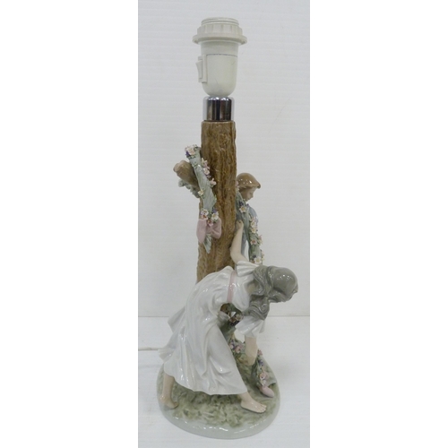 326 - Lladro lamp base in the form of two maidens decorating a tree with a floral garland, impressed no. 1... 