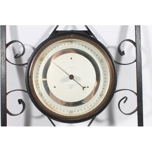 11 - J H Steward compensated barometer on metal frame.