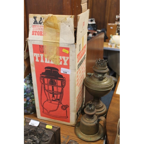 199 - Tilley X246B storm lantern boxed and two oil lamps.