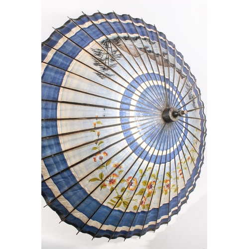 24 - Oriental painted paper and lacquered parasol with original metal cover.