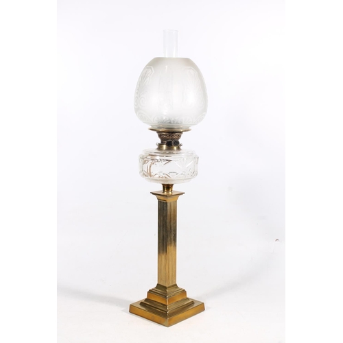 27 - Brass reeded column and glass oil lamp, 77cm high.