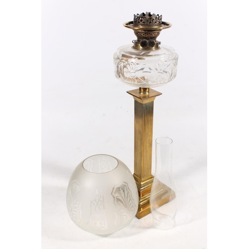 27 - Brass reeded column and glass oil lamp, 77cm high.