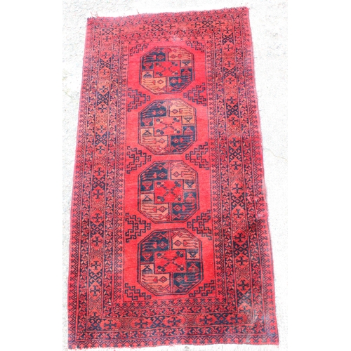 908 - Afghan red ground rug, 191cm x 103cm.