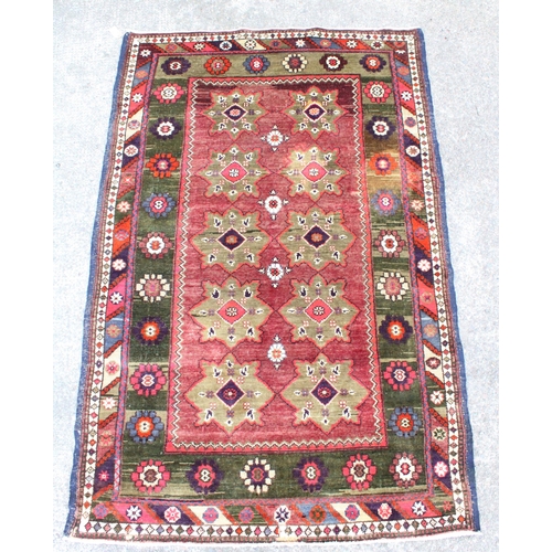 915 - Persian red ground and green rug, 197cm x 127cm.