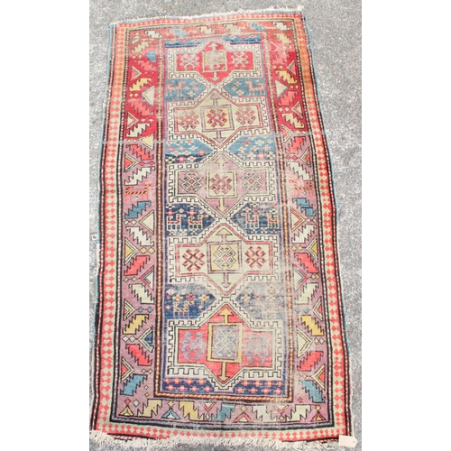 919 - Caucasian red ground and polychrome rug, 189cm x 96cm.