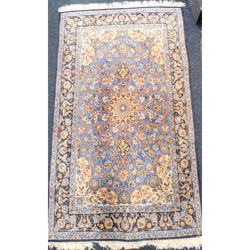 931 - Turksish blue ground rug with floral motifs, 192cm x 108cm.