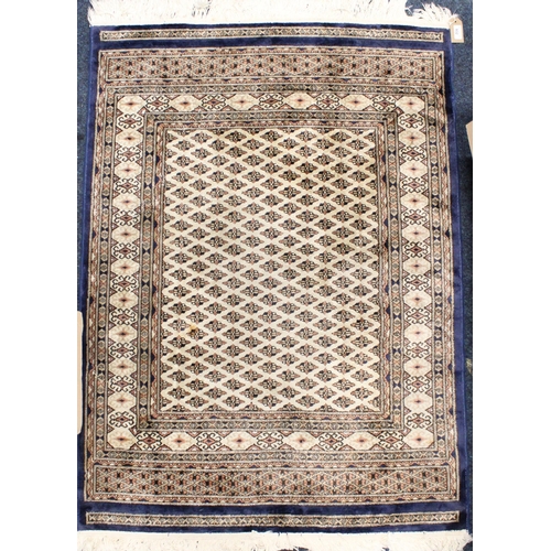 932 - Middle Eastern blue ground, cream and gold rug, 133cm x 95cm.