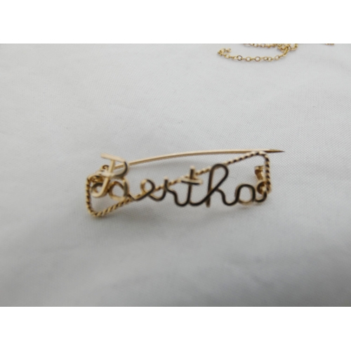 26 - 9k gold chains, entwined, 1.47g gross, and an unmarked name brooch, 'Bertha'.