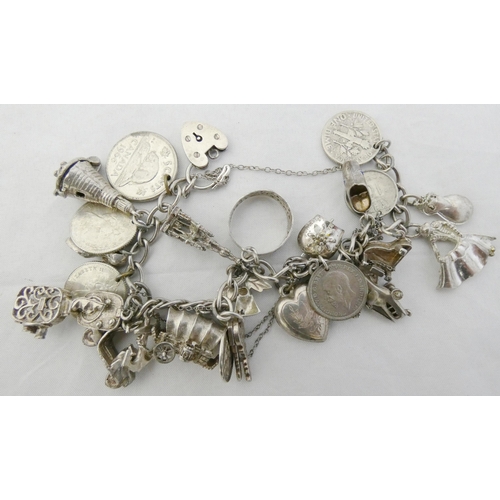 35 - Silver and nickel charm bracelet bearing assorted charms and attached coin pendants, some pendants m... 