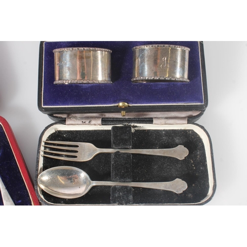 825 - Set of six hallmarked silver teaspoons, pair of silver napkin rings and a silver fork and spoon chri... 