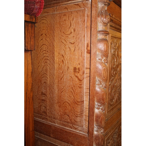 852 - Late Victorian large wardrobe heavily carved with masks and rococo acanthus motifs, flanked with twi... 