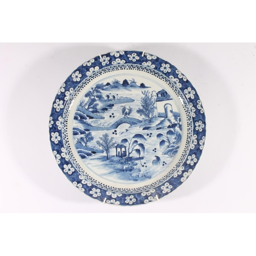 320 - Chinese porcelain willow pattern charger, late Qing period, decorated with a waterside scene within ... 