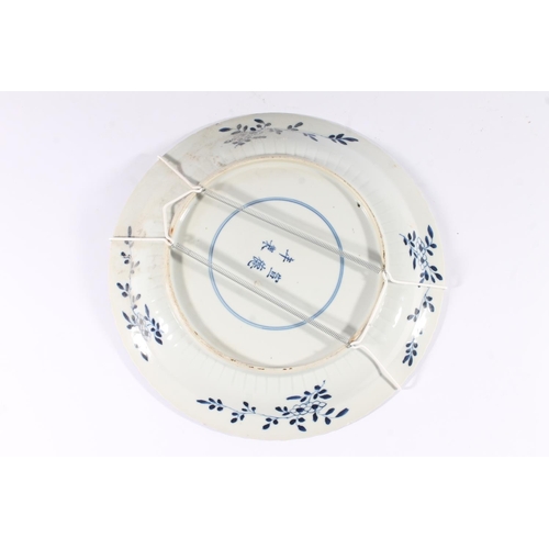 320 - Chinese porcelain willow pattern charger, late Qing period, decorated with a waterside scene within ... 