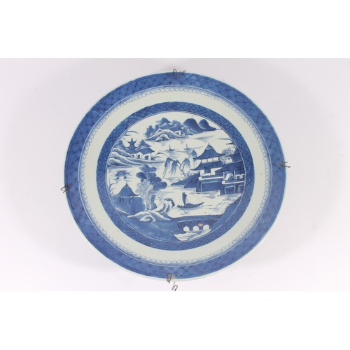 320 - Chinese porcelain willow pattern charger, late Qing period, decorated with a waterside scene within ... 