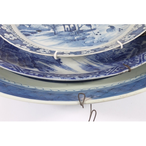 320 - Chinese porcelain willow pattern charger, late Qing period, decorated with a waterside scene within ... 